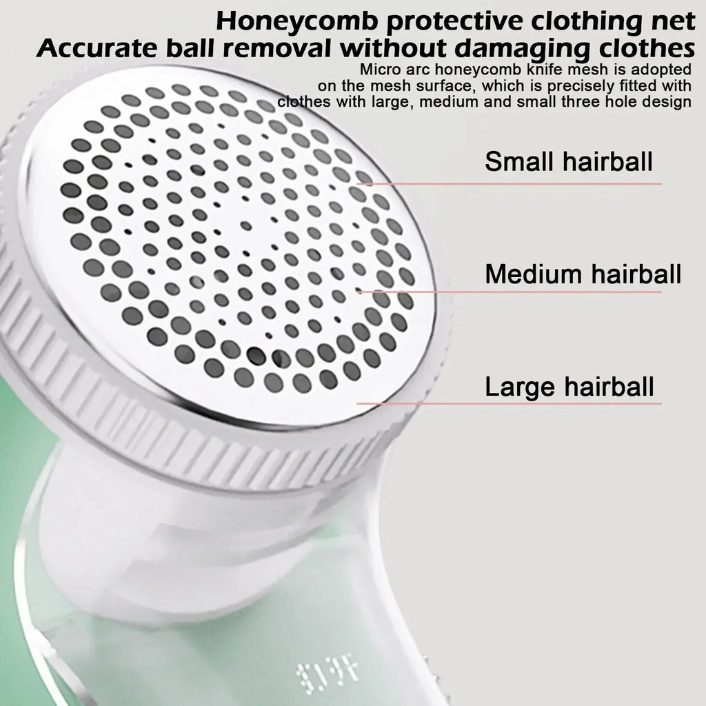 Close-up of a light green fabric shaver featuring a silver, honeycombed metal mesh head for removing lint.