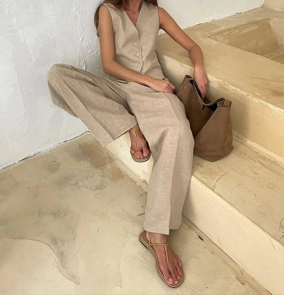 Beige linen-look waistcoat and wide-leg trousers co-ord set with button-up detail, paired with minimalist thong sandals.