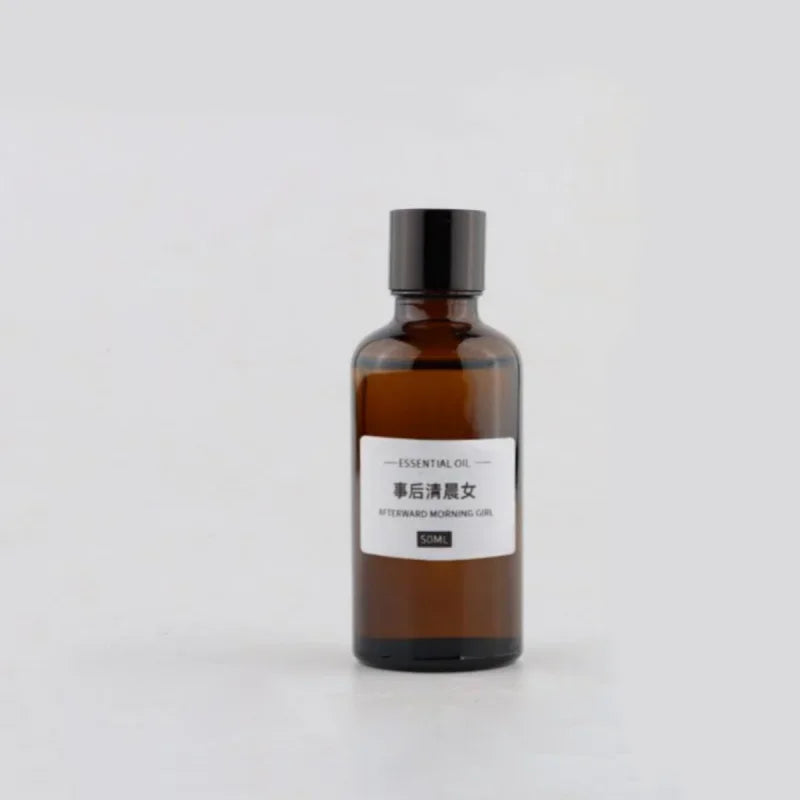 50ml amber glass essential oil bottle with a black screw cap and a minimalist white product label.