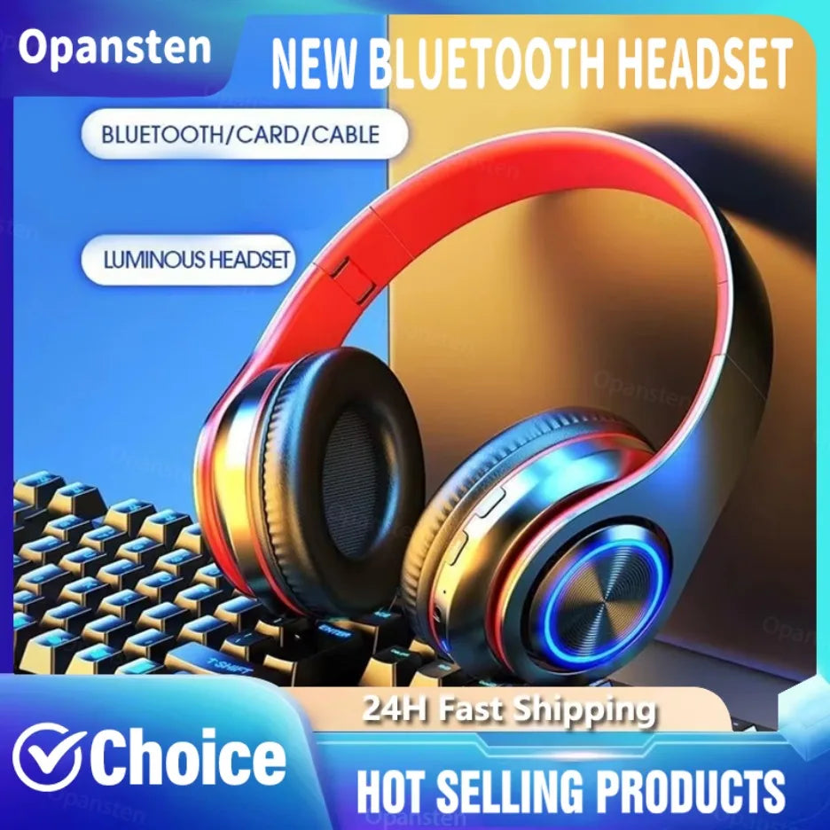 Wireless black and red gaming headset with circular blue LED ear cup lights, resting on a mechanical keyboard.
