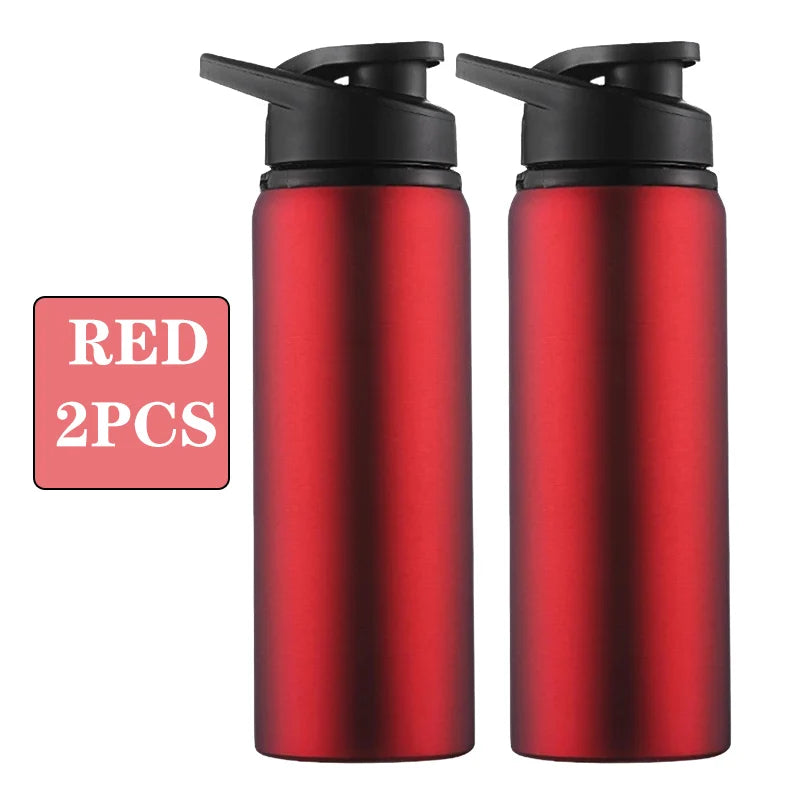 Two red sports water bottles with black flip-top lids, set against a plain white background.
