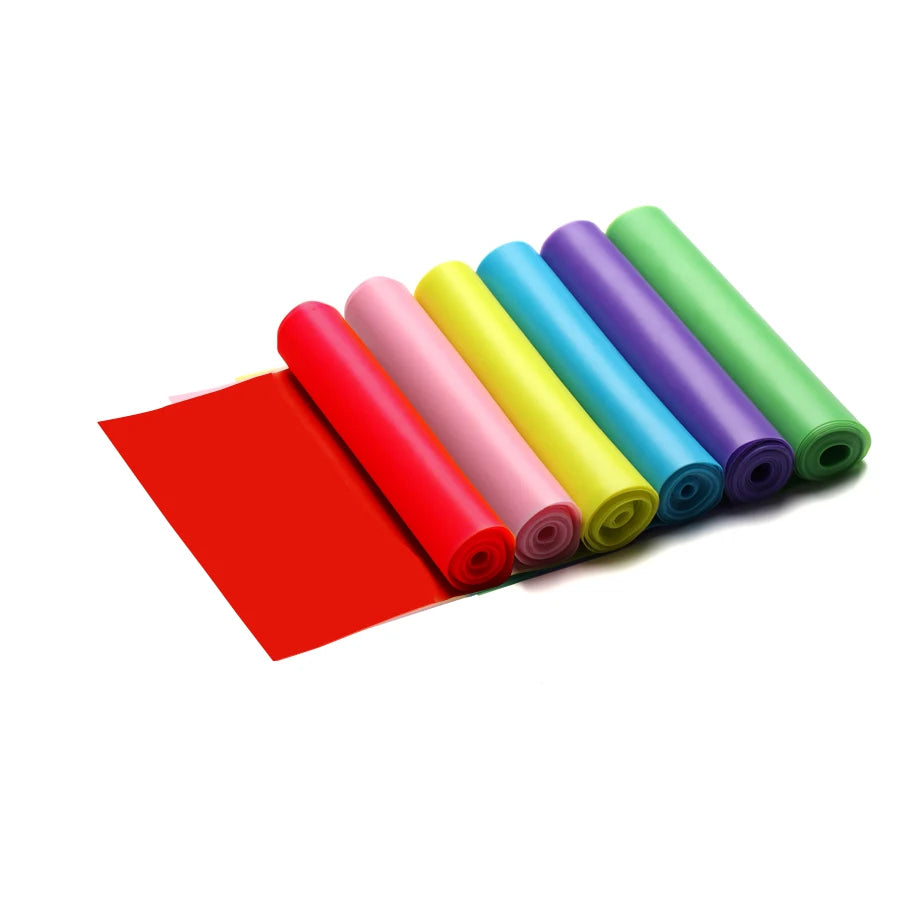 A set of six colourful, rolled exercise resistance bands in red, pink, yellow, blue, purple, and green.