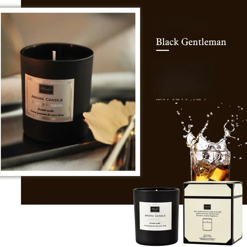 Black scented aroma candle in a sleek matte jar with a gold-trimmed label, shown with matching presentation box.