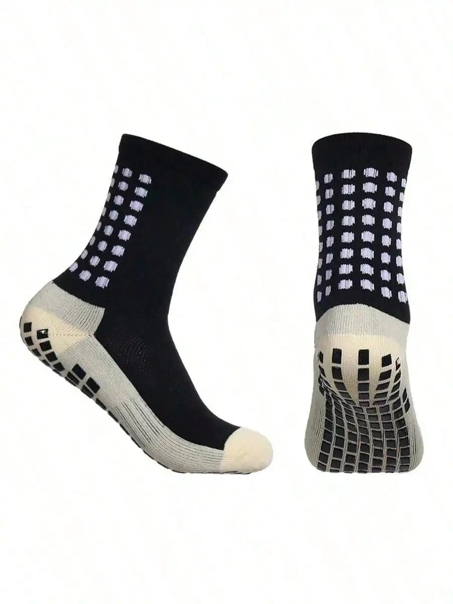 Black and white crew-length sports socks with checkered pattern, grip-sole technology, and reinforced heel and toe.