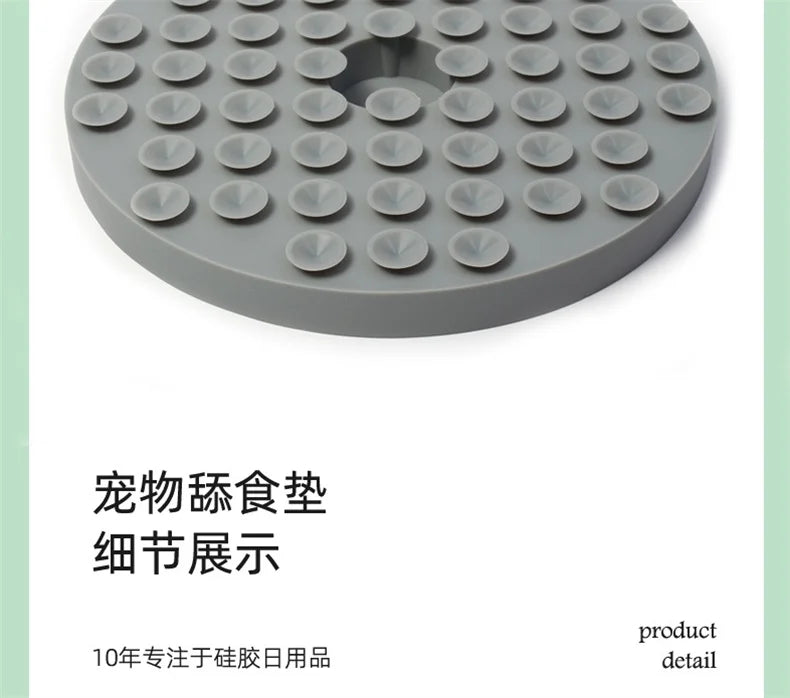 Round grey silicone pet lick mat with a grid of small suction cups for slow feeding.