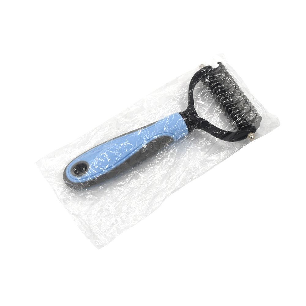 Blue and black pet dematting rake with metal teeth, sealed in clear plastic packaging.