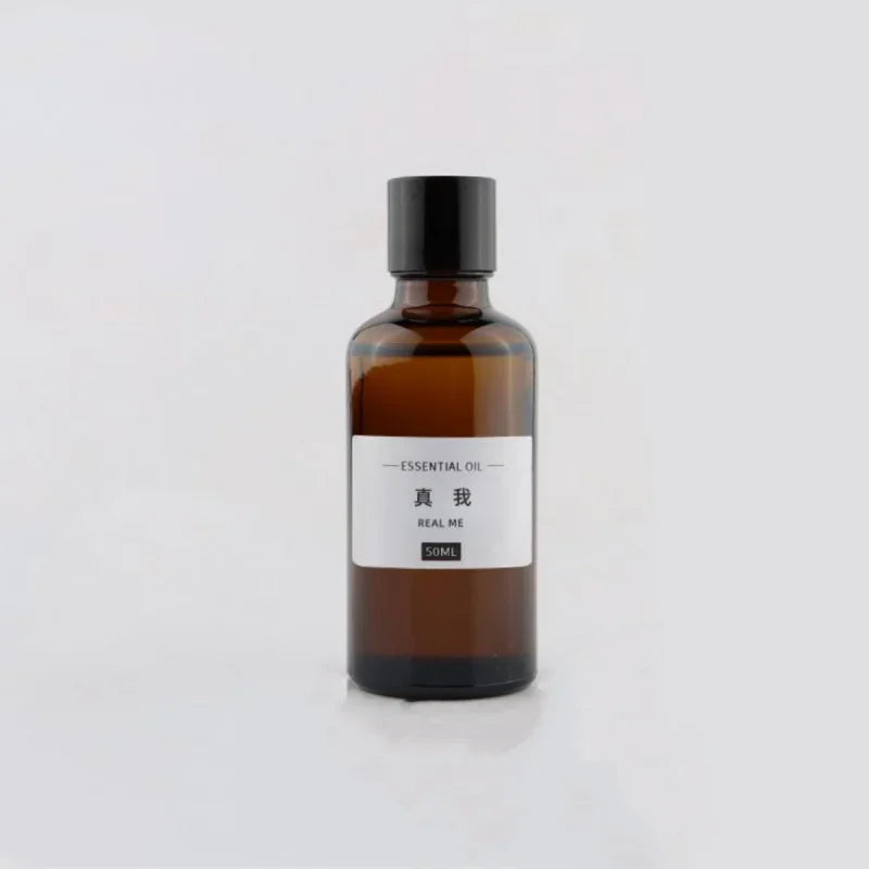 50ml amber glass bottle of essential oil with a black screw cap and minimalist white label.