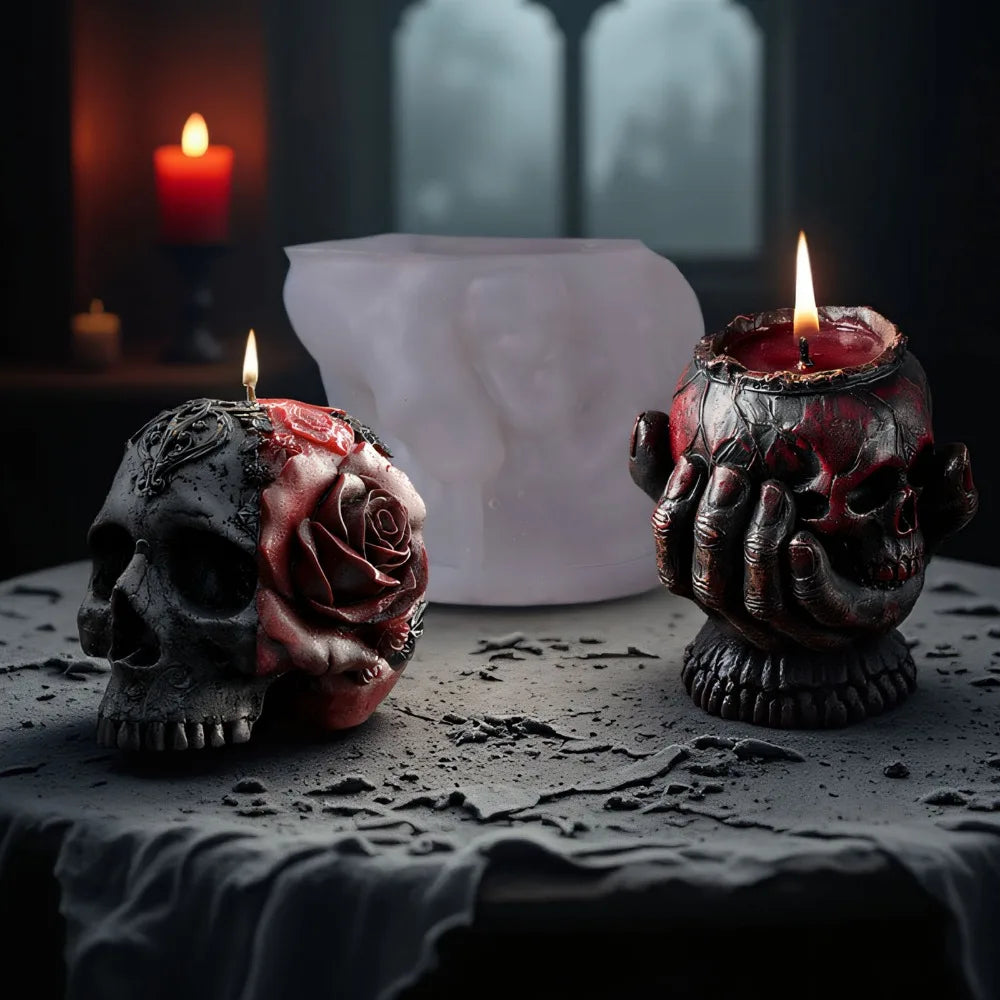 Translucent silicone mold with two finished gothic candles: a black-and-red skull with rose, and a red skull in hands.