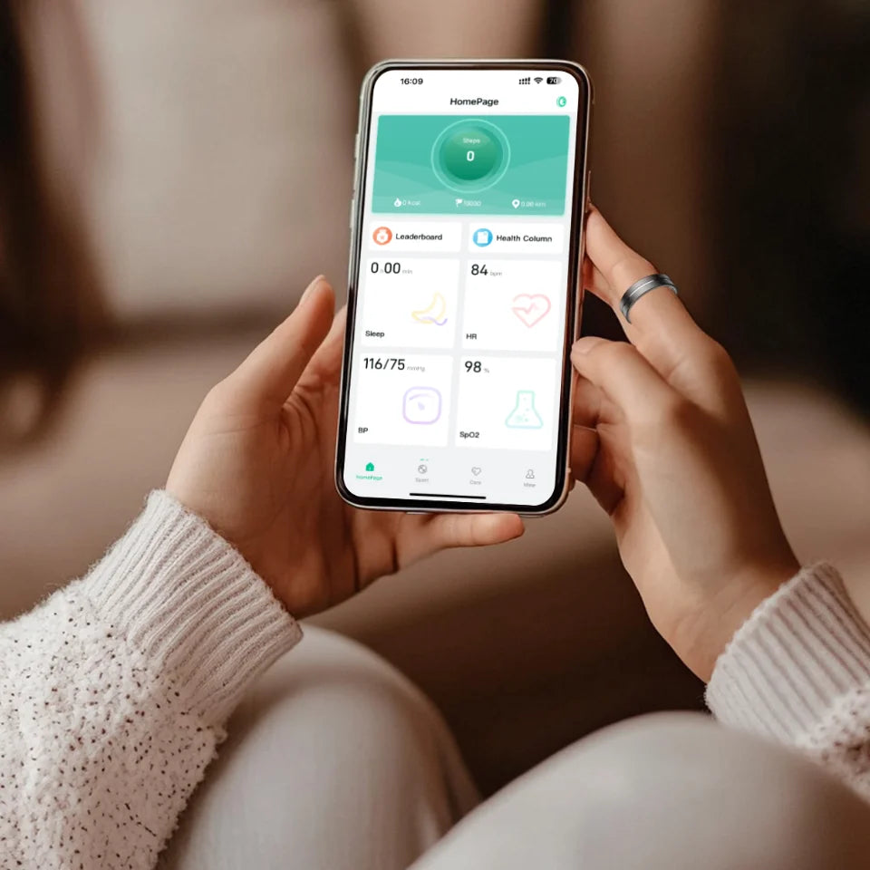 Hands holding a smartphone displaying health app data, with a sleek, brushed silver smart fitness ring on a finger.