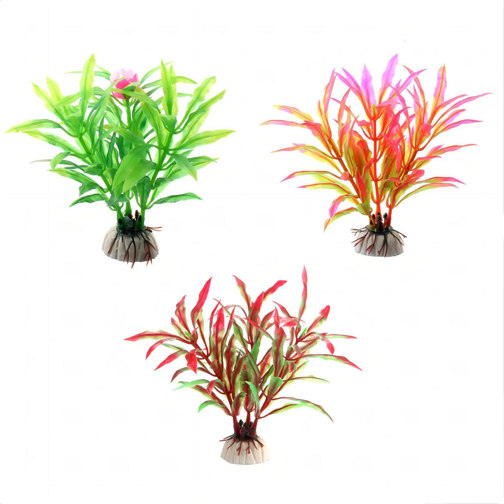 Three artificial aquarium plants with leafy stems in green, orange-pink, and red-green, set on weighted stone bases.