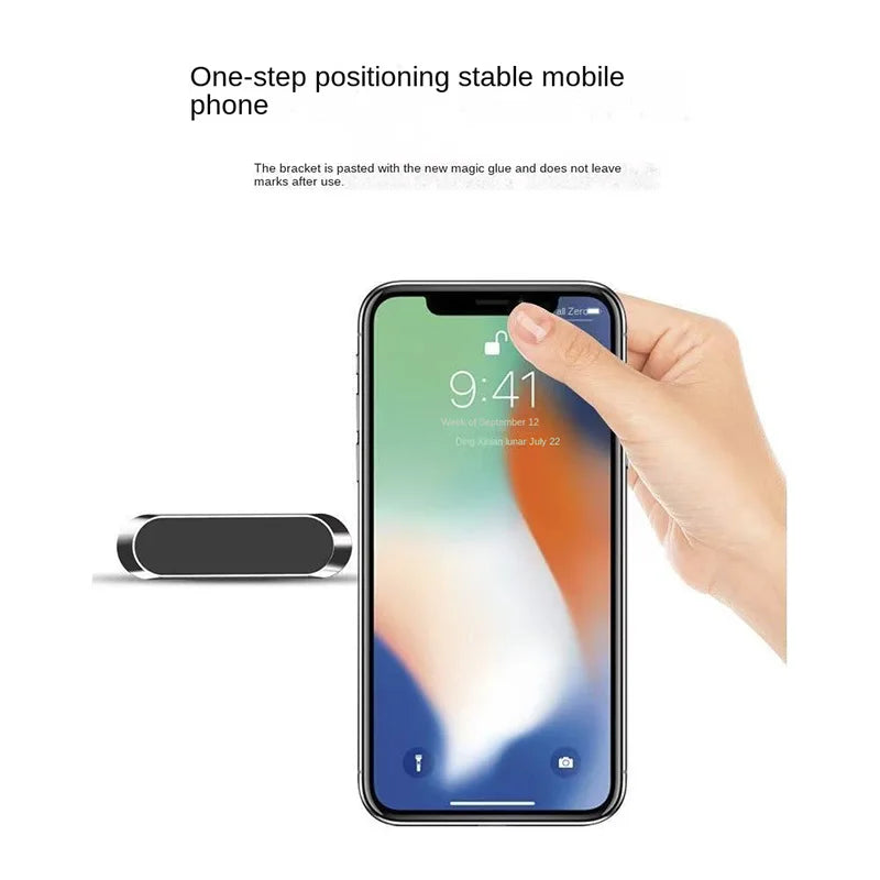 Small, rectangular, silver magnetic phone mount with a black center, shown next to a smartphone.