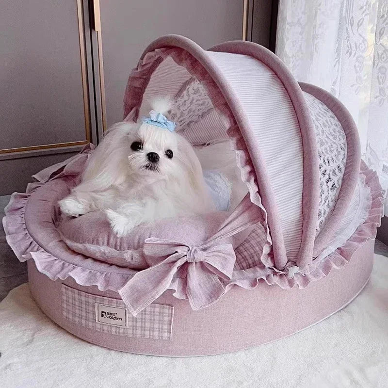 Pink round luxury dog house with a hooded lace canopy, ruffles, and a soft cushion inside with a small dog.