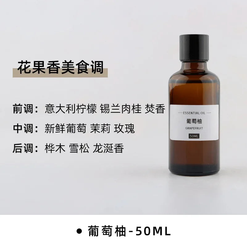 50ml amber glass bottle of Grapefruit essential oil with a black screw cap and minimalist white label.