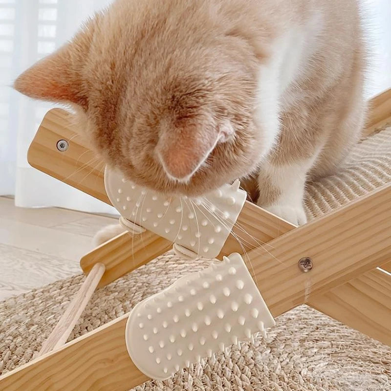 Ginger cat rubbing its cheek on two cream-coloured silicone grooming brushes attached to a wooden cat scratcher frame.