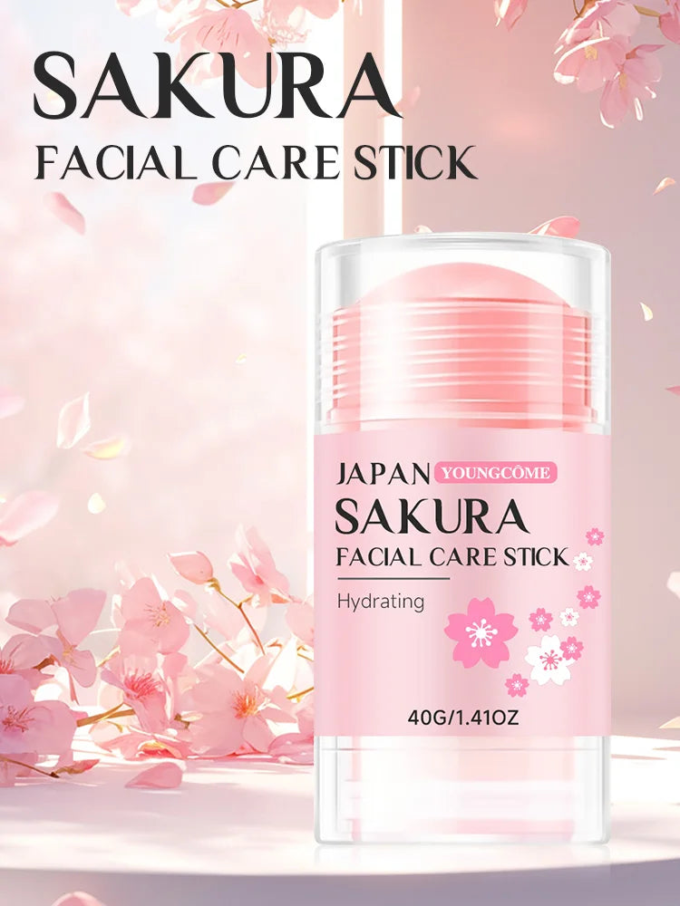 Pink sakura hydrating facial care stick in a portable twist-up container, set against a floral cherry blossom background.