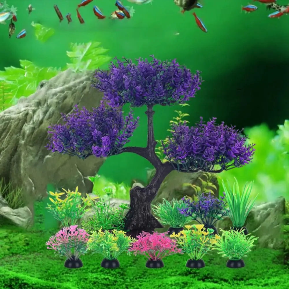 An artificial purple bonsai tree and various small, colorful plastic aquarium plants arranged in a green fish tank.