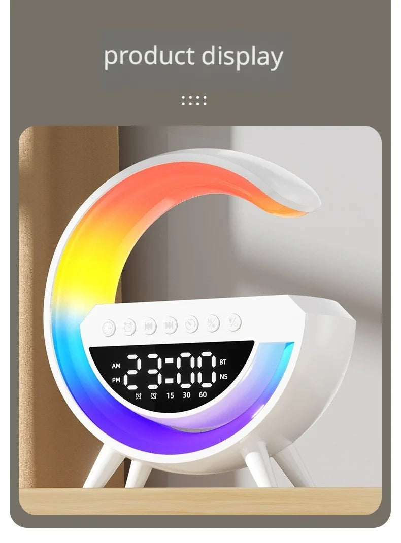 White G-shaped smart alarm clock with a colourful LED rainbow light, digital display, and wireless charging base.