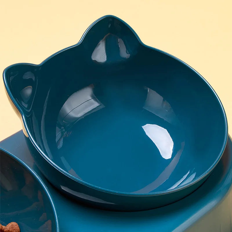 Dark teal cat-shaped pet bowl with a smooth, minimalist design on a pale yellow background.