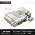 Modern white leather double bed with tufted headboard, integrated storage drawers, side desk, and built-in tech features.