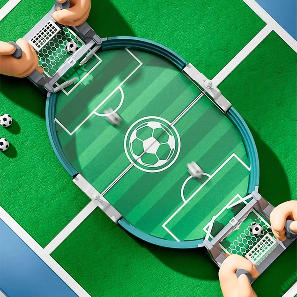 Tabletop football game with a green oval pitch, white markings, nets at each end, and small balls for two players.