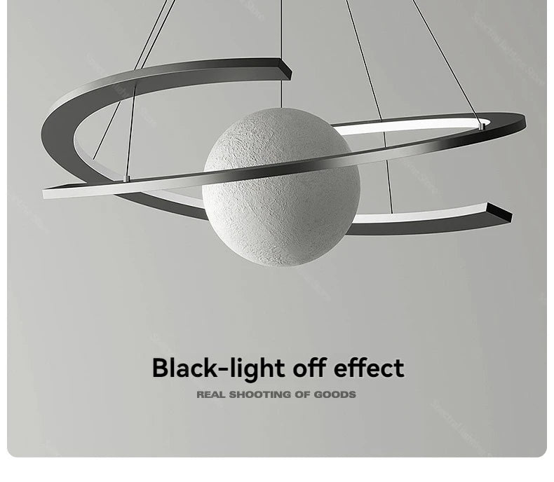 Modern pendant light with a central textured white sphere encircled by a sleek, black curved ring.