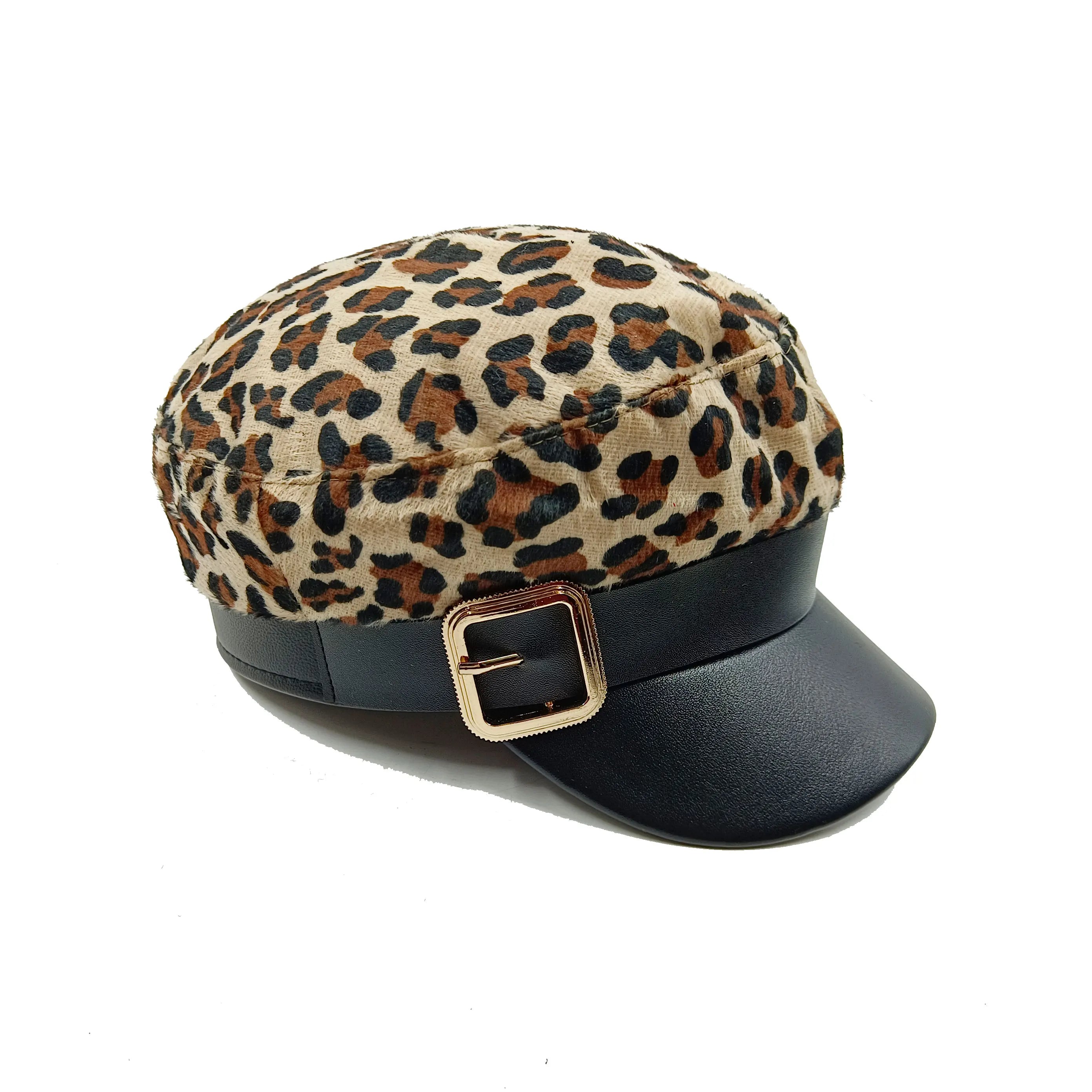 Leopard print beret hat with a black faux-leather peak, strap, and gold-tone buckle detail.
