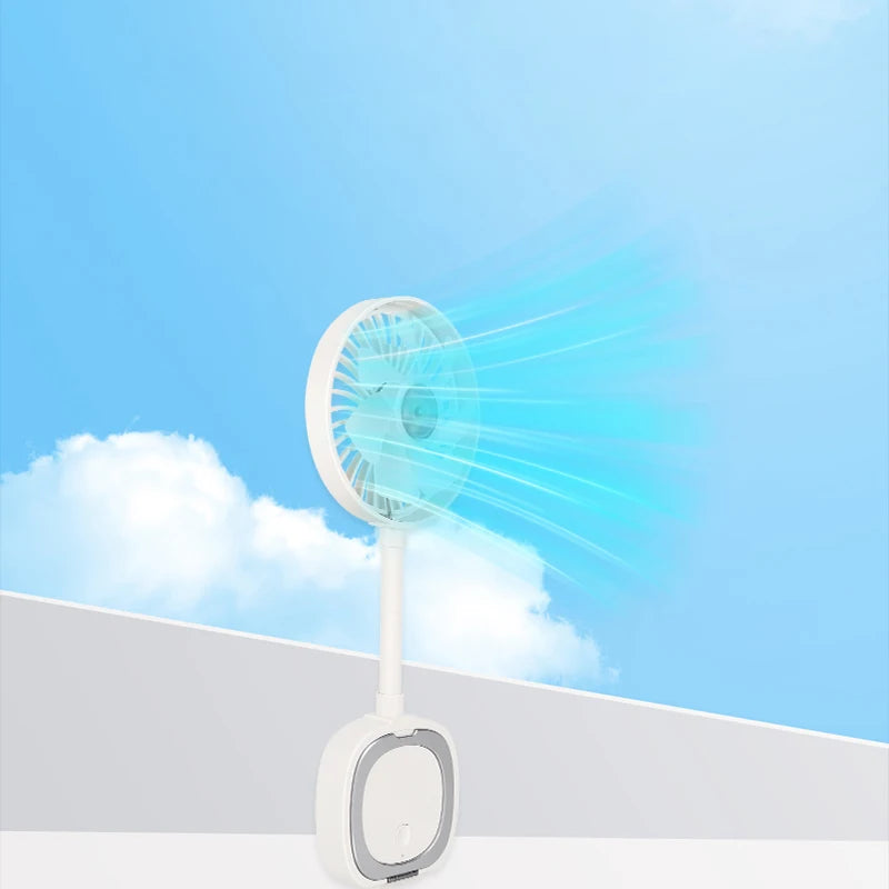 White portable desk fan with an adjustable stand, blowing a breeze against a blue sky background.
