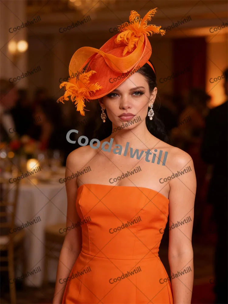 Elegant bright orange fascinator headpiece featuring sculptural netting and delicate feather accents.