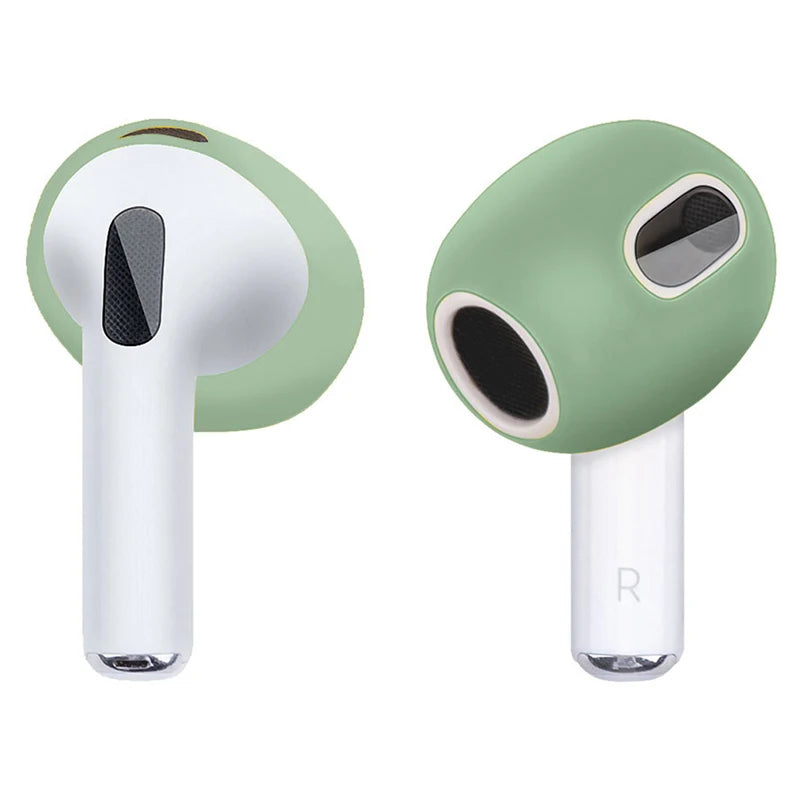 Sage green silicone covers for AirPods 3, providing a snug fit for the earbud heads.