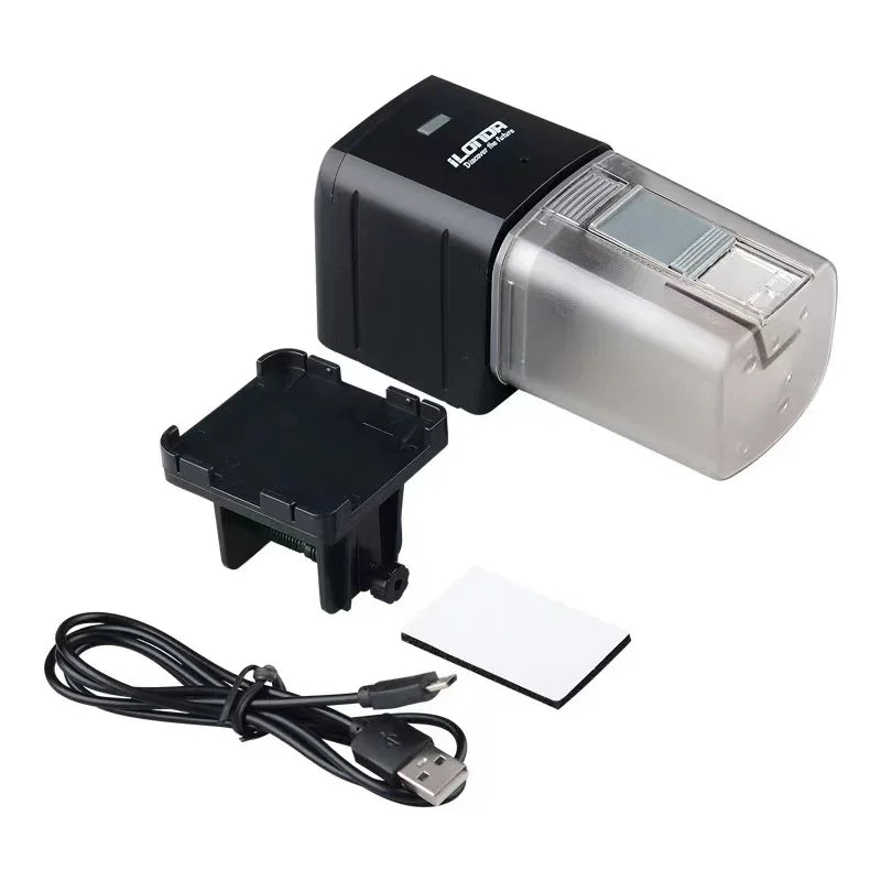 Automatic fish feeder with a black housing, clear food container, mounting bracket, USB cable, and adhesive pad.