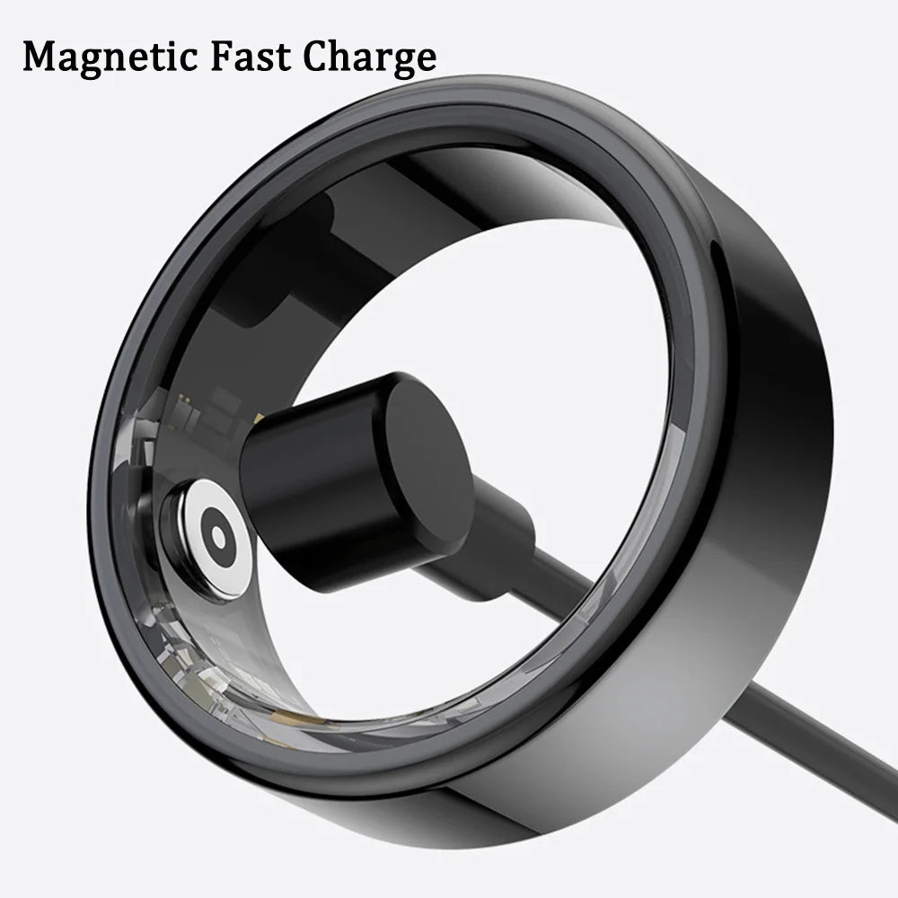 A sleek black smart fitness ring shown with its magnetic fast-charging cable attached.