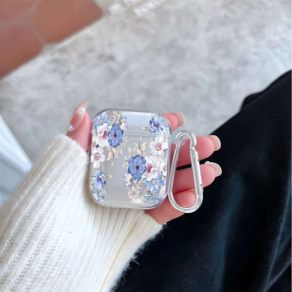 Clear AirPods case with blue floral print and silver carabiner, held in a hand. Suitable for AirPods 1/2.