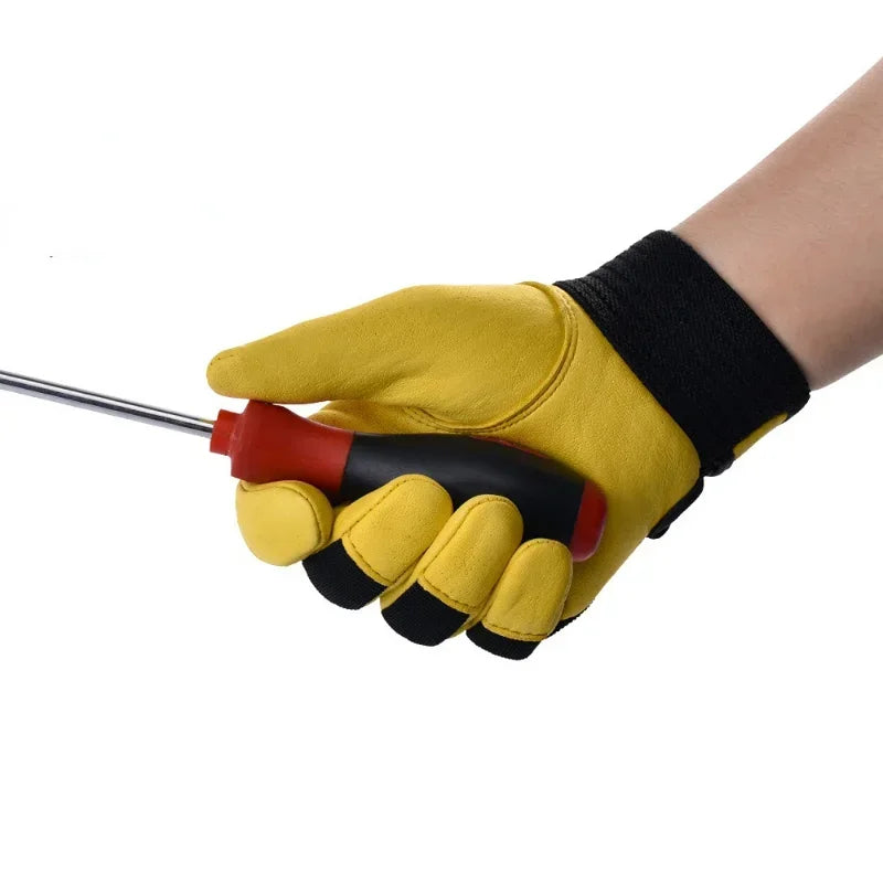 A person wearing yellow and black cowhide leather work gloves, holding a screwdriver.