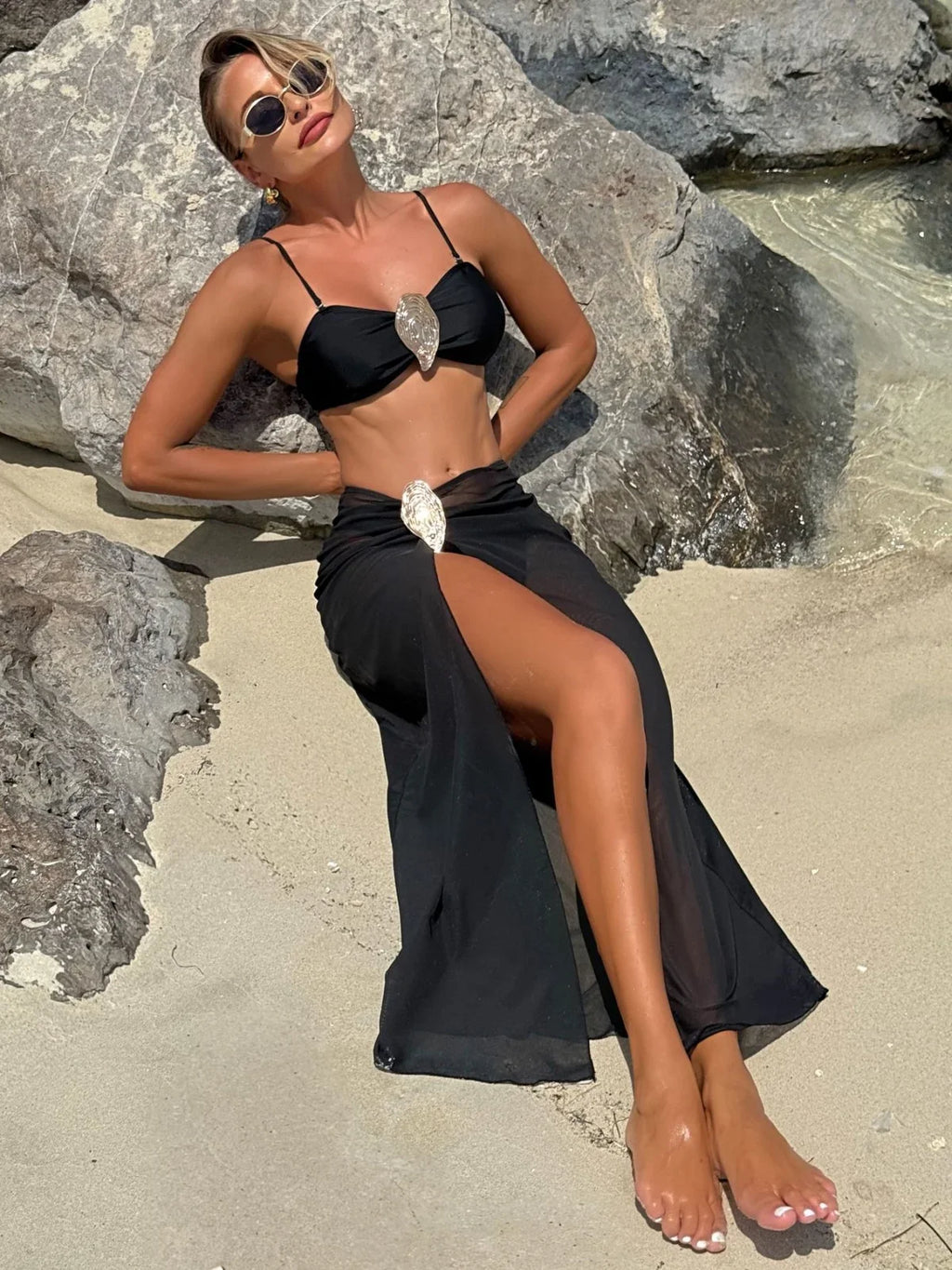 Black 3-piece bikini set with metallic oyster buckle, push-up top, and sheer mesh long skirt with slit.
