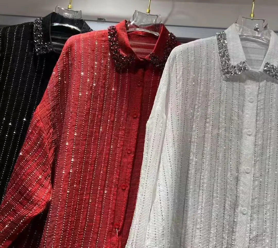 Three button-down shirts in black, red, and white, featuring pleated fabric, vertical glitter stripes, and jewelled collars.