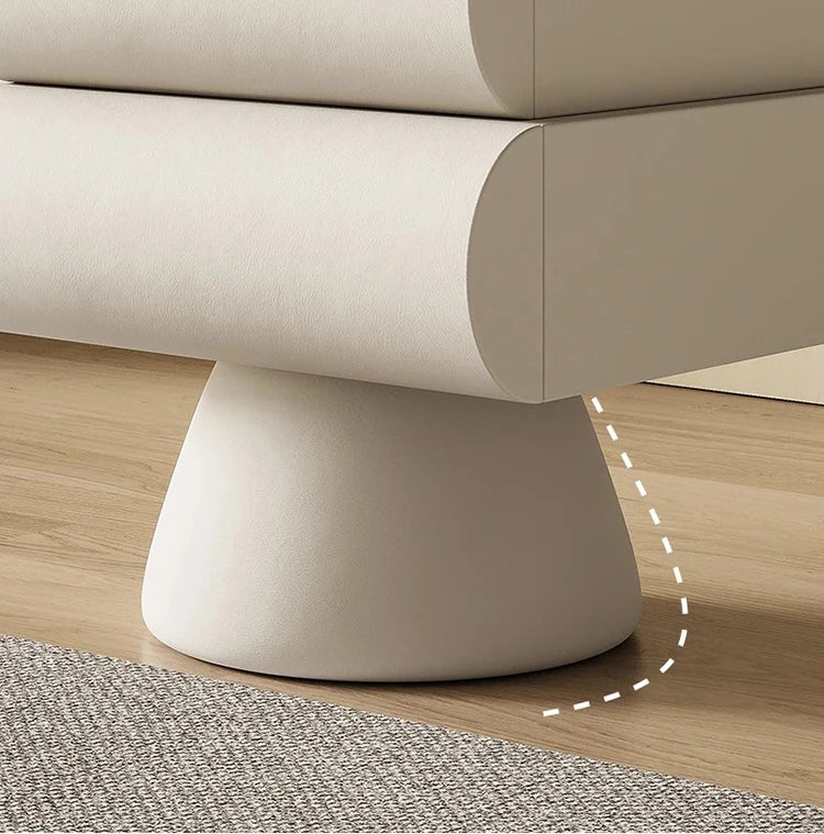 Cream-coloured modern bedside table with two curved drawers, mounted on a solid, tapered pedestal base.