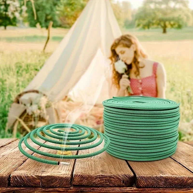 Green mosquito repellent coils stacked on a rustic wooden table with one burning coil in the foreground.