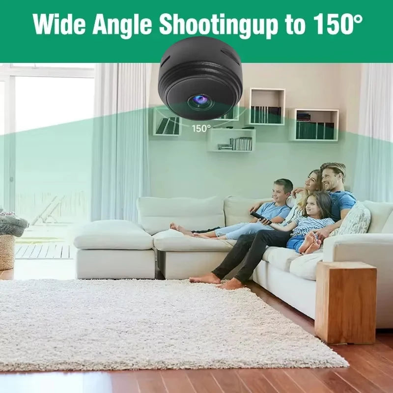 Small black dome-shaped plastic security camera with a 150-degree wide-angle lens, shown monitoring a living room.