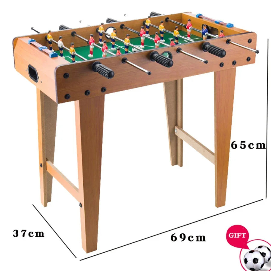 Wooden foosball table with green pitch, red and yellow players, black grip handles, and manual score counters.