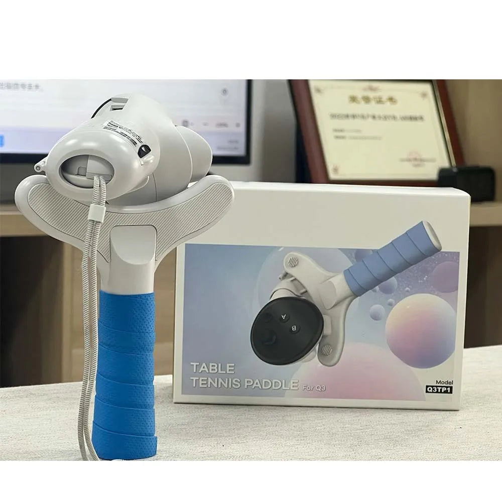 White and blue AMVR table tennis paddle adapter for Quest 3 with textured handle grip, standing before its box.