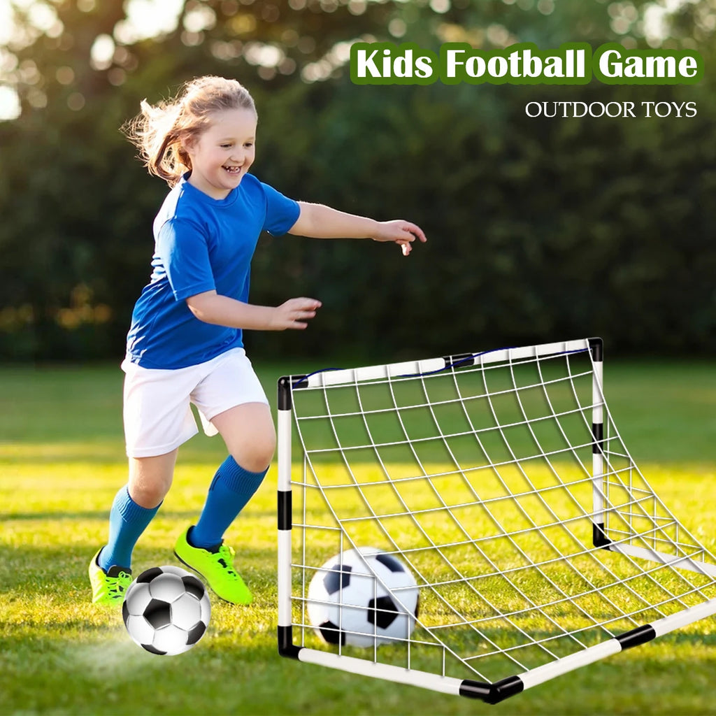 A child playing with a portable white and black football goal set and a classic black-and-white soccer ball outdoors.