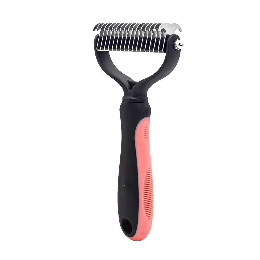 Pet dematting rake with a metal comb head and a black and pink non-slip handle, isolated on a white background.