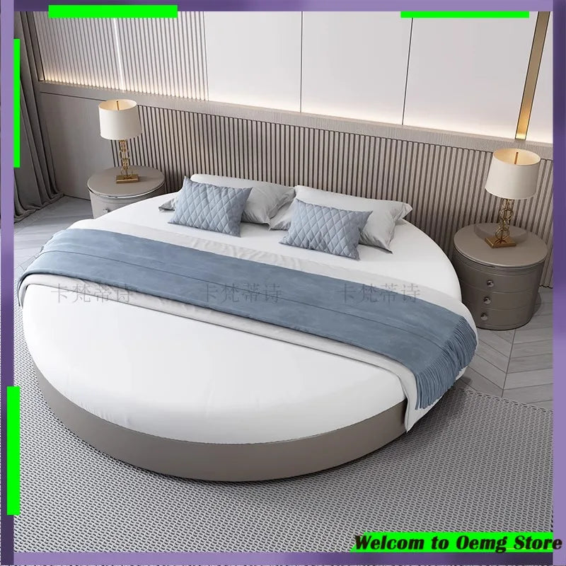 Modern, minimalist circular bed frame in a soft grey finish, styled with white bedding and a blue throw.