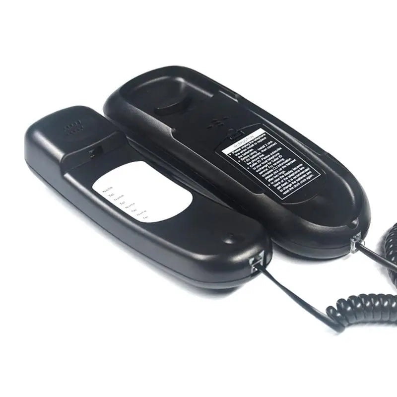 Black wall-mountable corded telephone with coiled cable, handset with memo pad, and rear instruction label.
