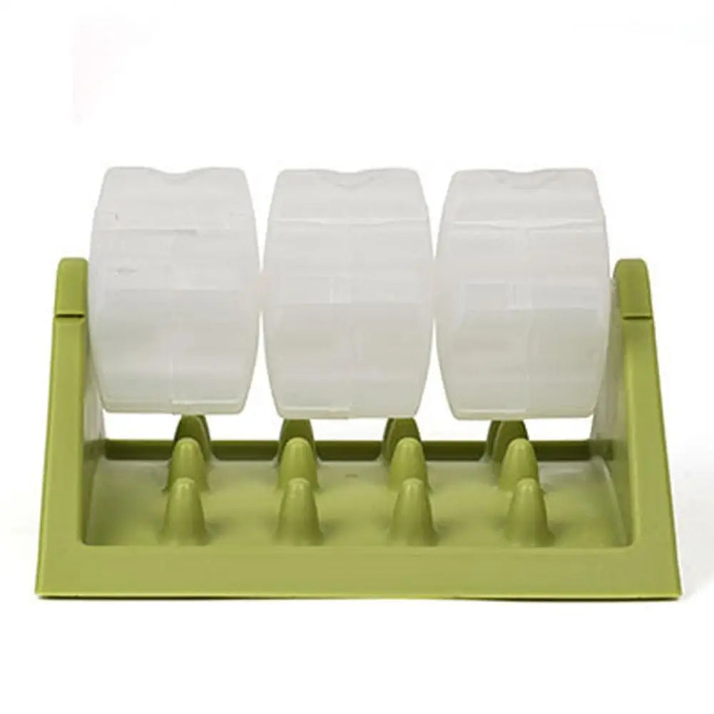 Green interactive dog puzzle feeder with three translucent, rotating treat-dispensing barrels and a textured base.