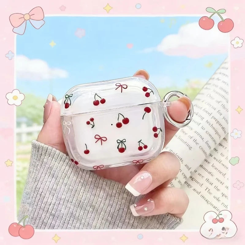Clear plastic AirPods Pro case with red cherry and bow print, featuring an attached metal ring clip.