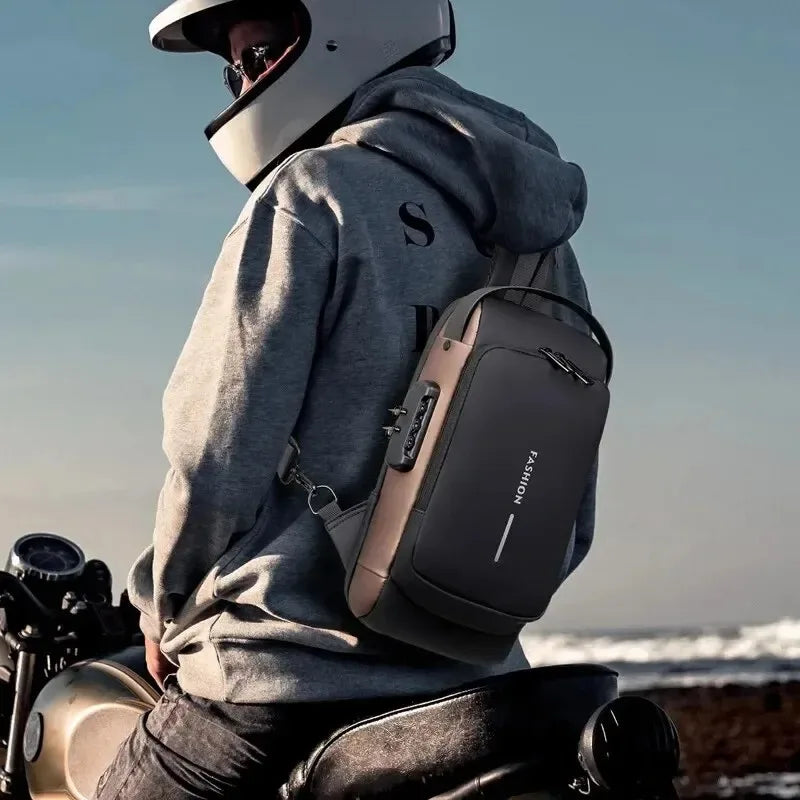 Black and grey waterproof anti-theft sling bag with a combination lock, worn by a motorcyclist.