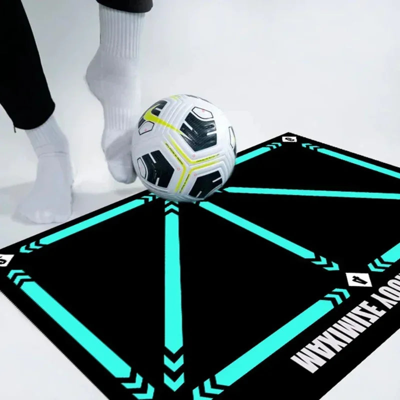 Black football training mat with turquoise directional arrows, featuring a person practicing with a white soccer ball.