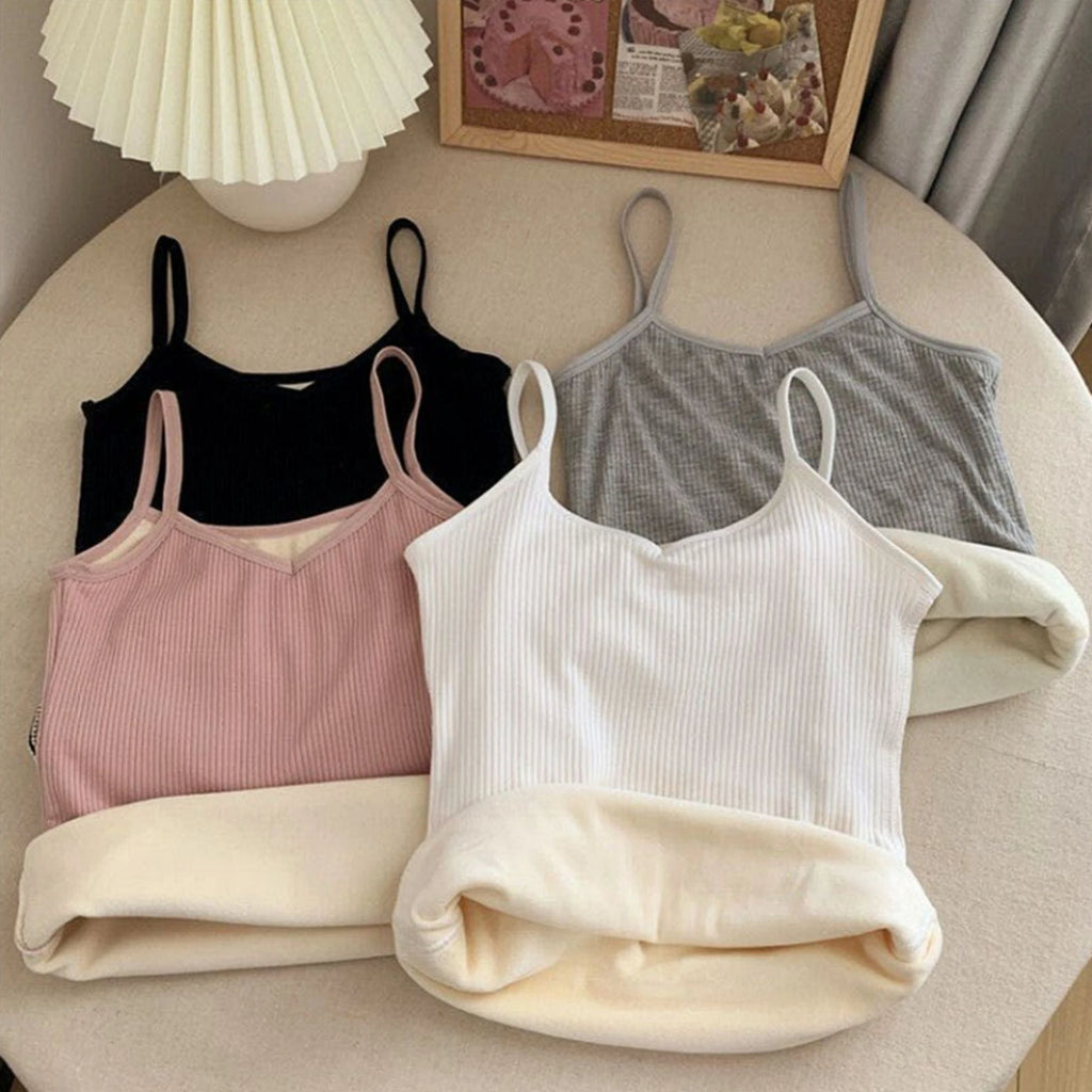 Four ribbed camisole tops in black, grey, pink, and white, featuring a warm, fleece-lined interior and thin straps.