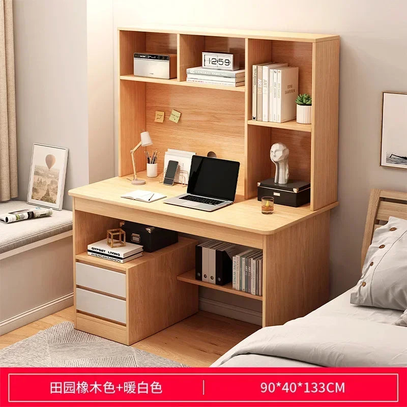 Light wood desk and hutch with integrated shelving, laptop, small lamp, and two lower drawers with white fronts.